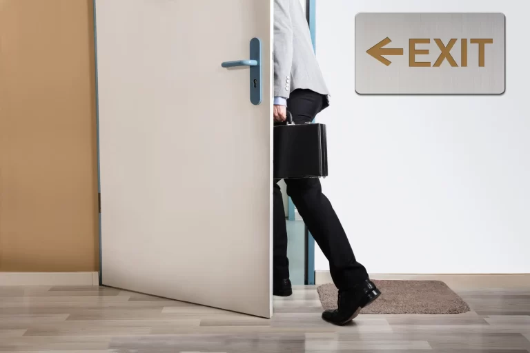 person walking out the door from an office