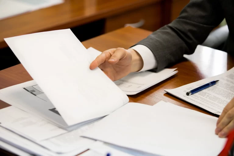 solicitor reading legal documents at their desk