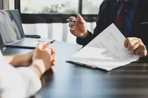 two people drawing up a settlement agreement contract